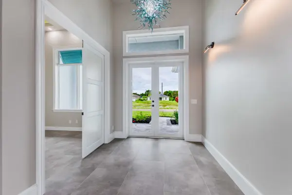 Coastal style bedroom with tray ceiling designed by Conquest Builders Corp in Cape Coral, FL